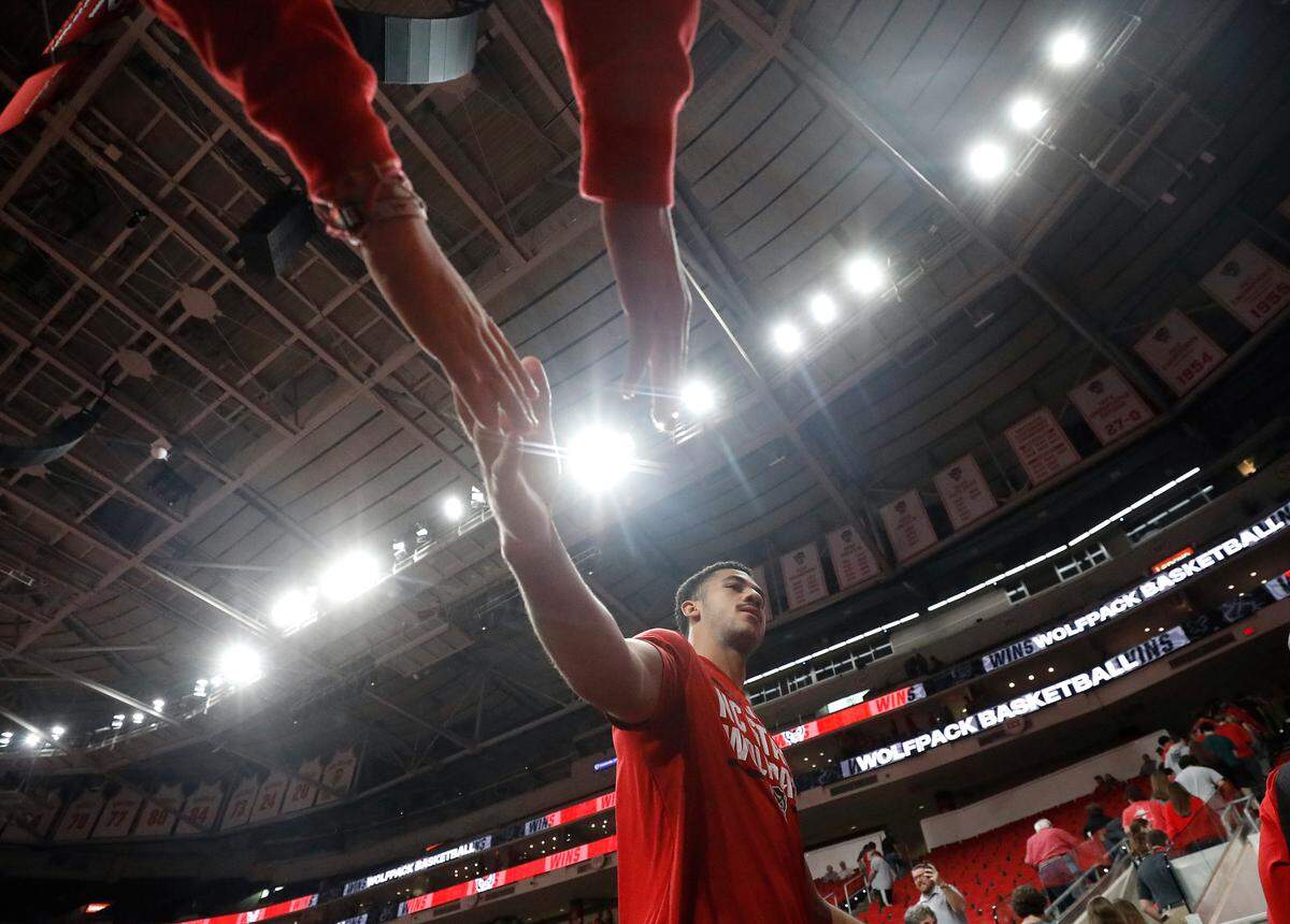 N.C. State’s Ismael Diouf high-fives fans following the Wolfpack’s 81-72 win over Presbyterian on Friday, Nov. 8, 2024, at Lenovo Center in Raleigh, N.C.
