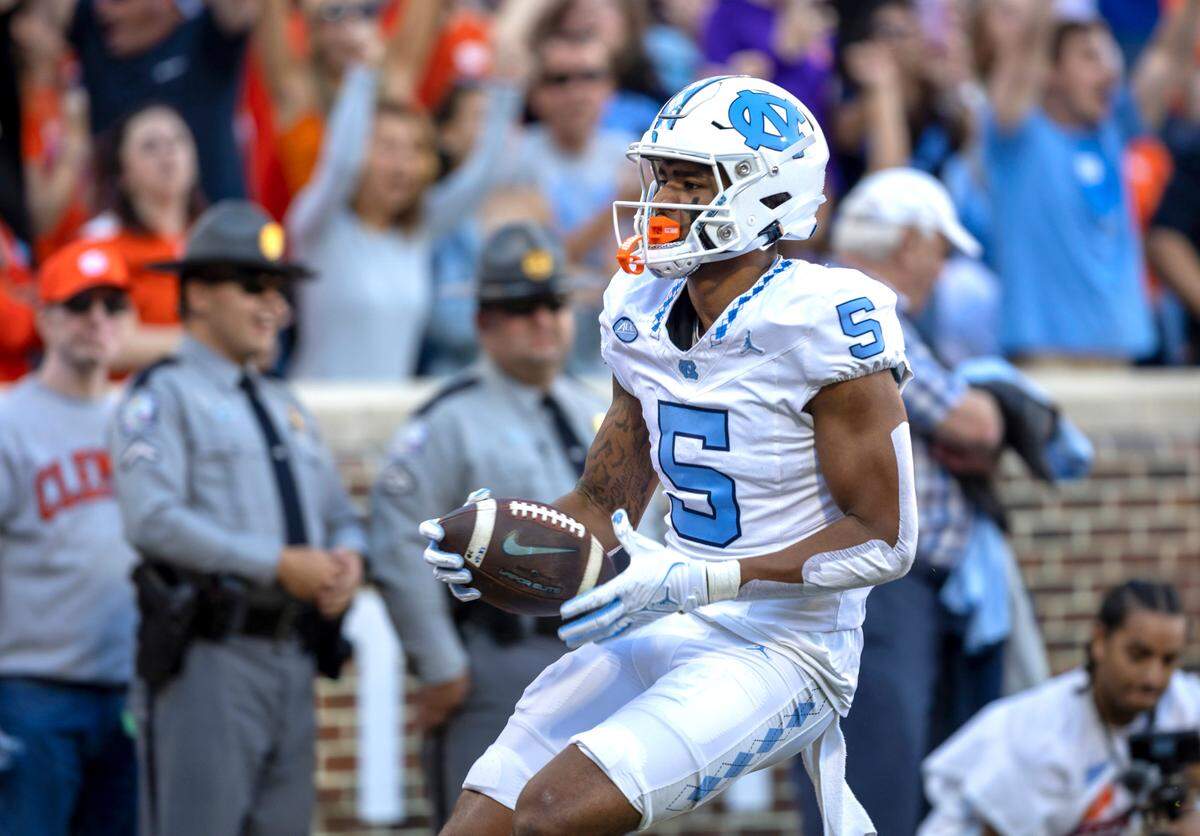 North Carolina’s J.J. Jones (5) scores on a 33-yard pass reception from quarterback Drake Maye to give the Tar Heels a 7-0 lead over Clemson in the first quarter on Saturday, November 18, 2023 at Memorial Stadium in Clemson, S.C.