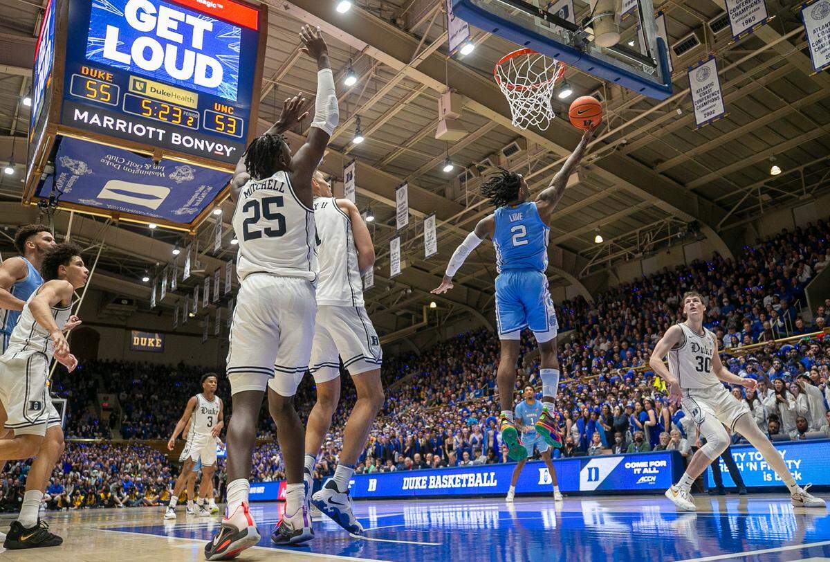 North Carolina’s Caleb Love (2) breaks through the Duke defense for a reverse layup in the second half on Saturday, February 4, 2023 at Cameron Indoor Stadium in Durham, N.C. Love scored 12 points.