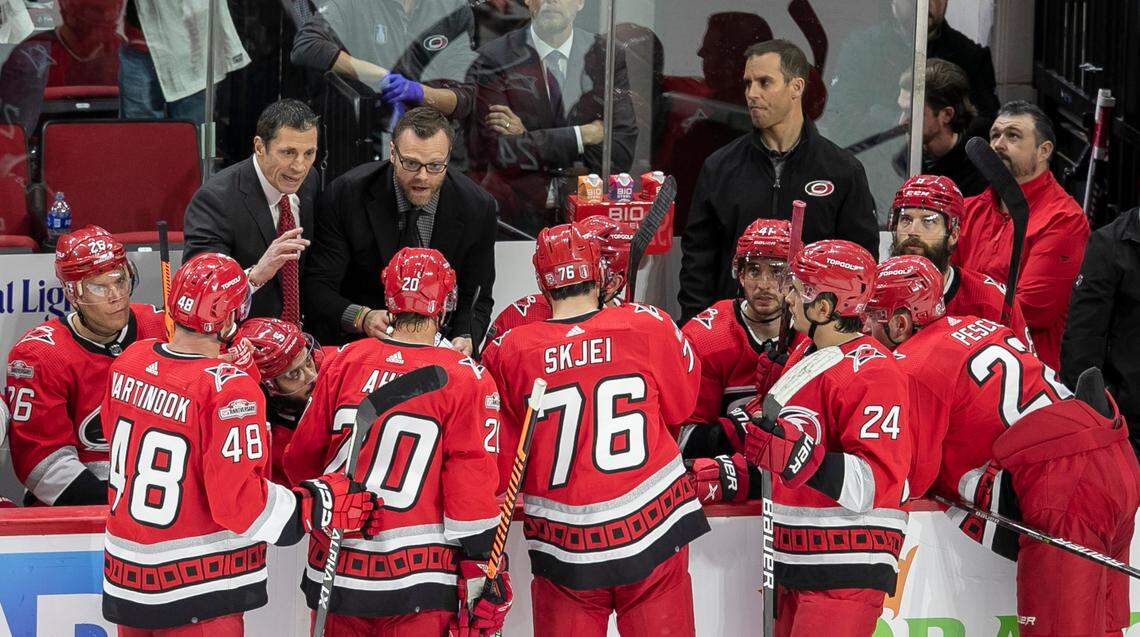 Carolina Hurricanes’ coach Rod Brind’Amour and assistant coach Tim Gleason huddle with players during the closing minutes of the third period against the New York Islanders on Monday, April 17, 2023 at PNC Arena in Raleigh, N.C.
