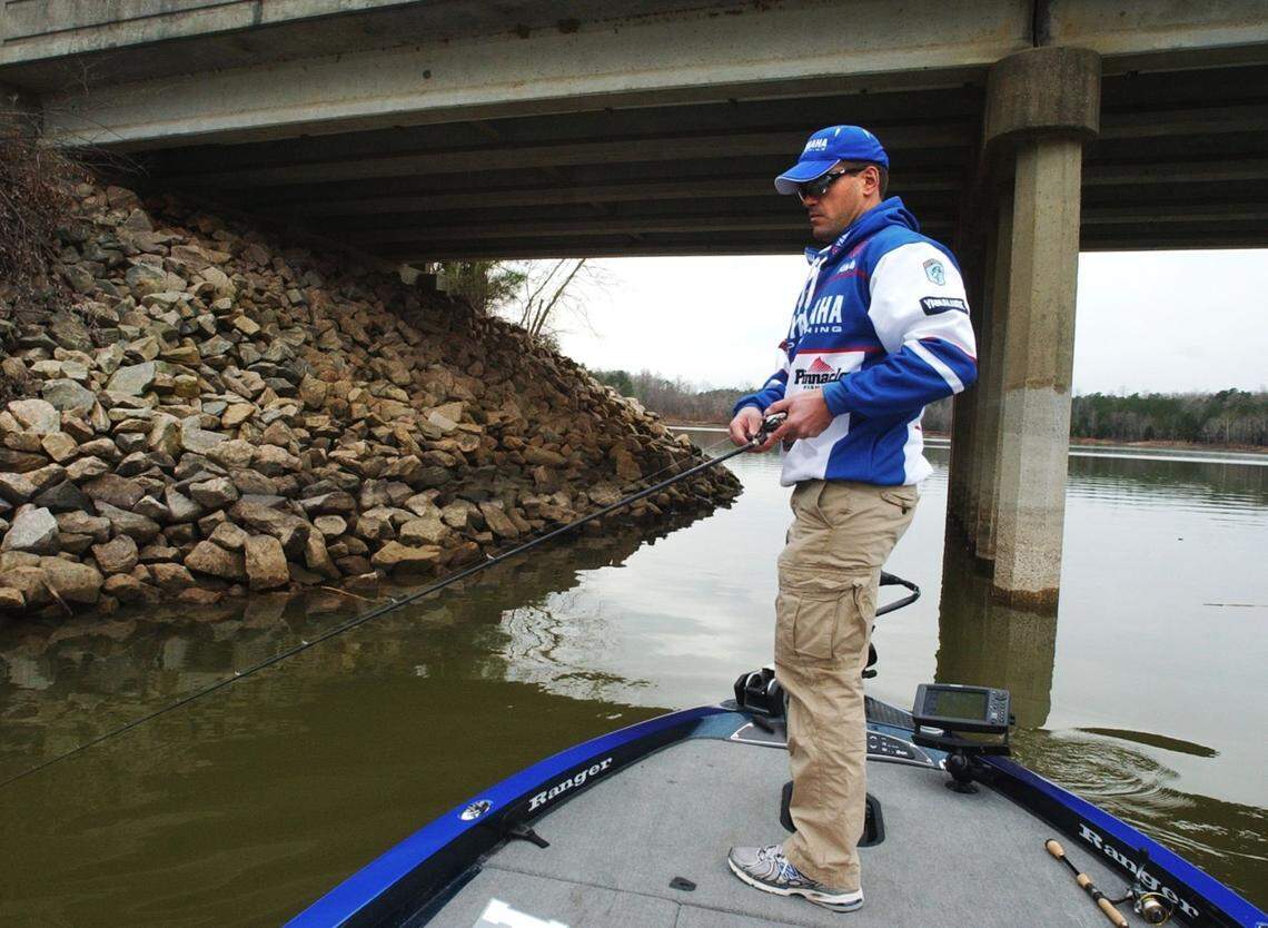 Wake Forest bass pro Dave Wolak fishes next to a bridge on Falls Lake as he prepares for this week’s Bassmaster Classic in Louisiana.