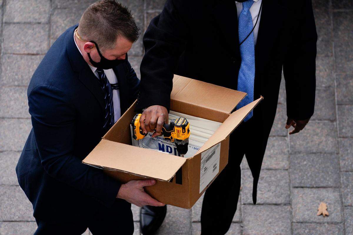 Officials transfer motorcade license plates ahead of the 59th Presidential Inauguration in Washington, Wednesday, Jan. 20, 2021. Joe Biden was sworn in as the 46th president of the U.S.