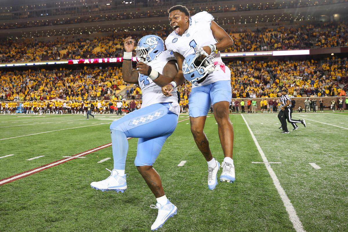 Aug 29, 2024; Minneapolis, Minnesota, USA; North Carolina Tar Heels defensive lineman Travis Shaw (4) and wide receiver Jordan Shipp (1) celebrate their teams win against the Minnesota Golden Gophers after the game at Huntington Bank Stadium. Mandatory Credit: Matt Krohn-USA TODAY Sports