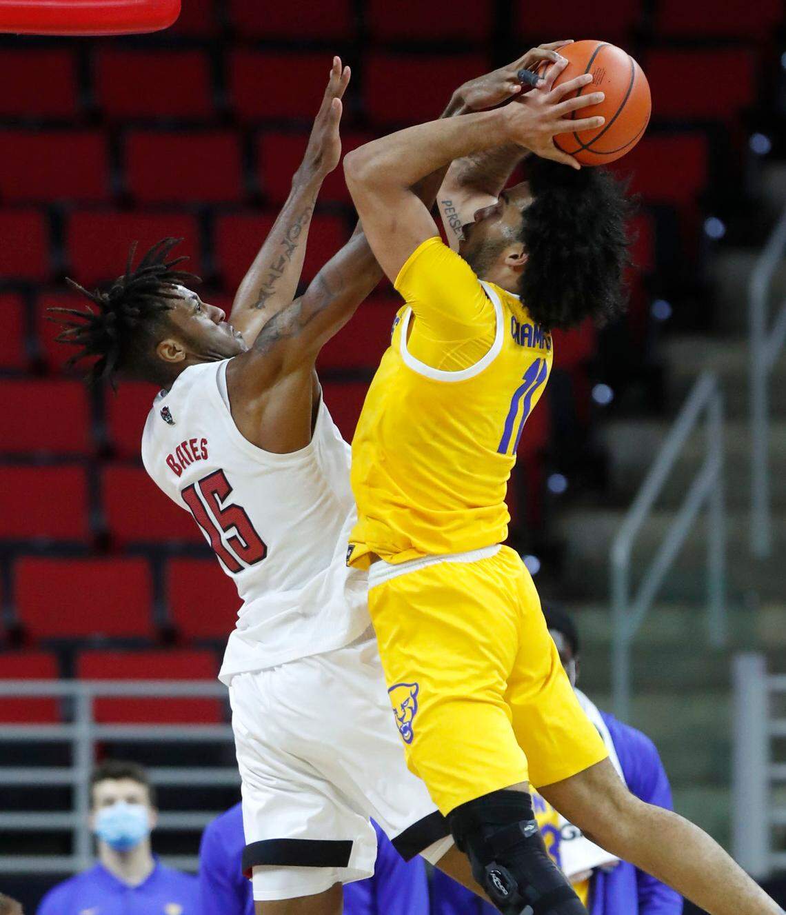 N.C. State’s Manny Bates (15) blocks the shot by Pittsburgh’s Justin Champagnie (11) during the second half of N.C. State’s 65-62 victory over Pittsburgh at PNC Arena in Raleigh, N.C., Sunday, February 28, 2021.