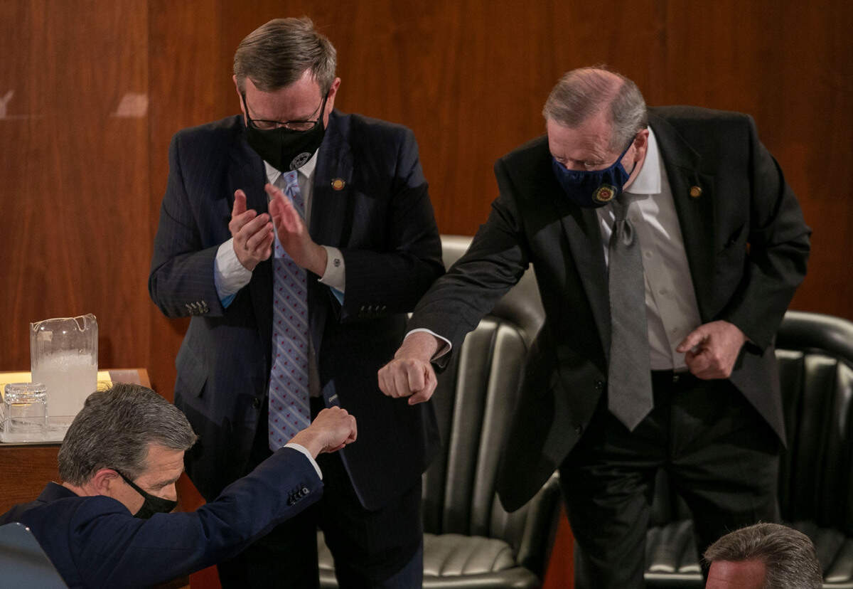 Senator Phil Berger fist bumps North Carolina Governor Roy Cooper after Cooper delivered his State of the State address before a joint session of the North Carolina House and Senate on Monday, April 26, 2021 in Raleigh, N.C.
