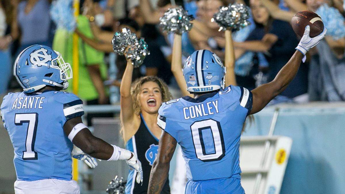 North Carolina’s Ja’Qurious Conley (0) celebrates after an interception of Virginia quarterback Brennan Armstrong in the third quarter on Saturday, September 18, 2021 at Kenan Stadium in Chapel Hill, N.C.
