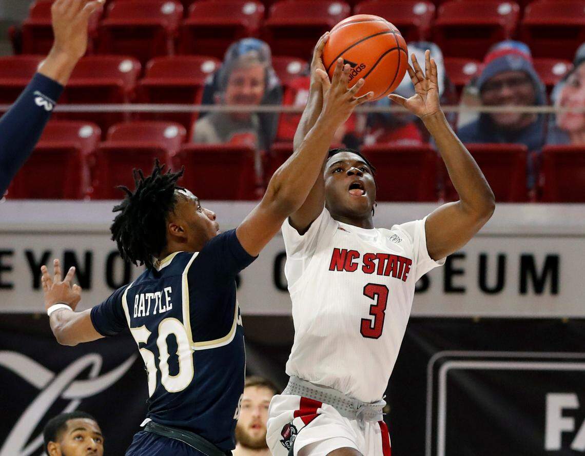 N.C. State’s Cam Hayes (3) heads to the basket as Charleston Southern’s Malik Battle (50) defends during N.C. State’s game against Charleston Southern in the Wolfpack Invitational at Reynolds Coliseum in Raleigh, N.C., Wednesday, Nov. 25, 2020.