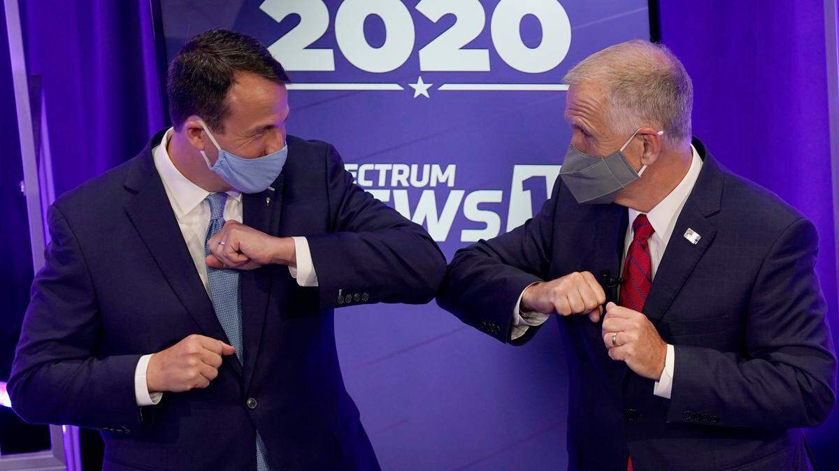 Democratic challenger Cal Cunningham, left, and U.S. Sen. Thom Tillis, R-N.C. bump elbows before their debate last Thursday, a day before both made big news that raised questions about their campaigns for the pivotal Senate race.