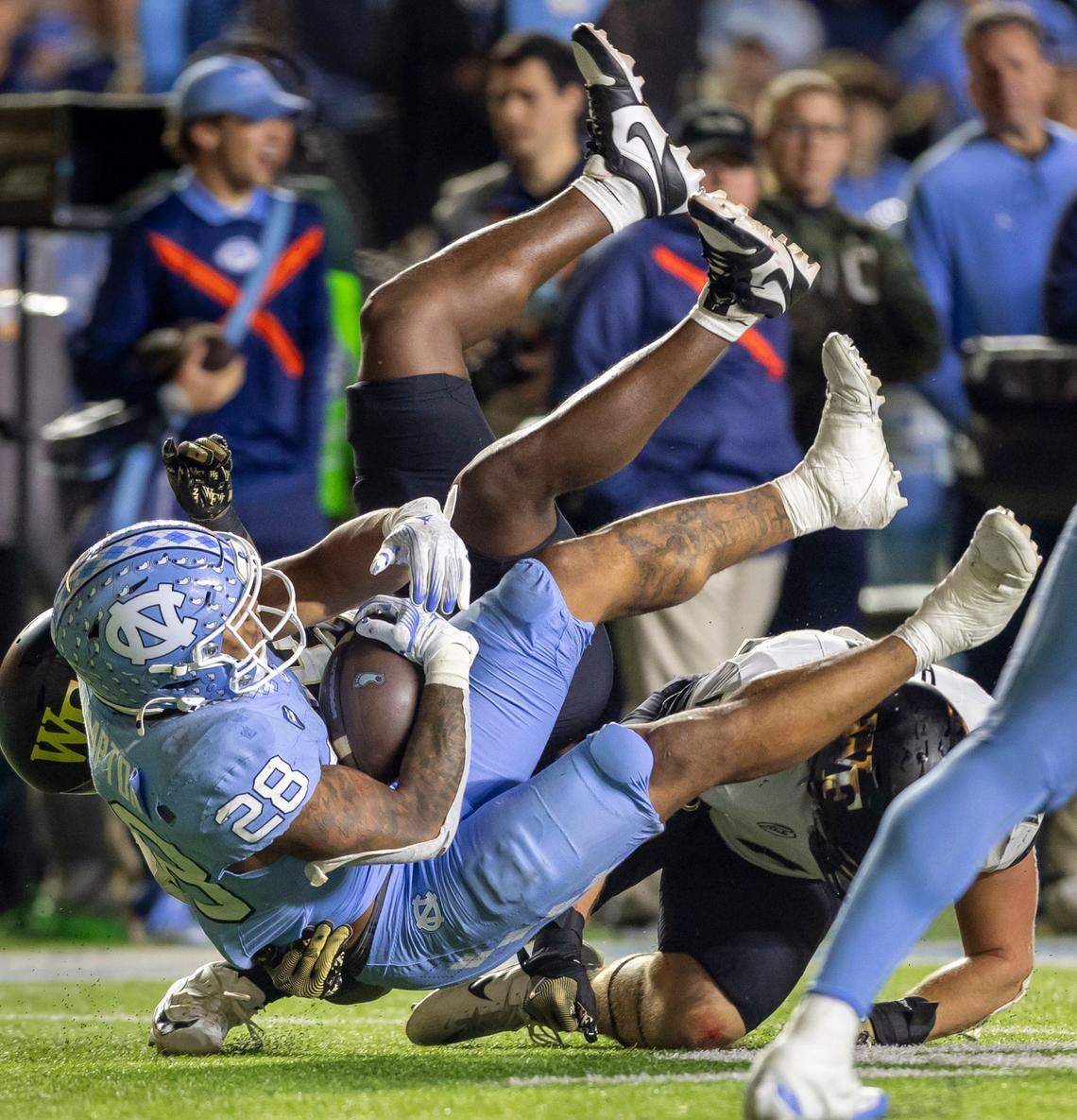 North Carolina running back Omarion Hampton (28) is stopped after a gain of 26-yards in the second quarter against Wake Forest on Saturday, November 16, 2024 at Kenan Stadium in Chapel Hill, N.C. Hampton had a career night rushing for 244 yards and one touchdown.