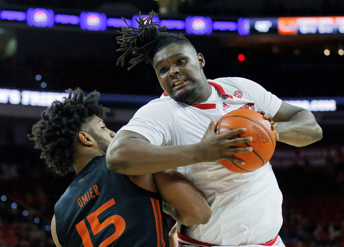 N.C. State’s DJ Burns Jr. posts up against Miami’s Norchad Omier during the second half of the Wolfpack’s 74-68 win on Tuesday, Jan. 30, 2024, at PNC Arena in Raleigh, N.C.