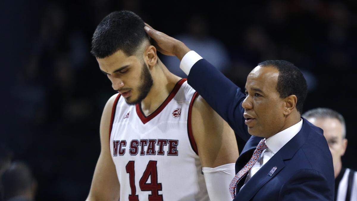 N.C. State head coach Kevin Keatts talks with Omer Yurtseven during a timeout in the Wolfpack's 91-87 loss to Boston College in the ACC tournament on March 7.