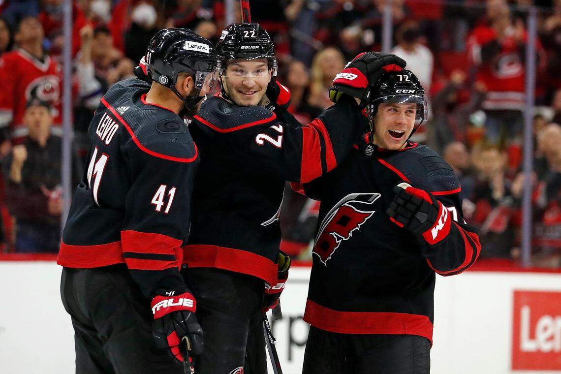 Carolina Hurricanes’ Jack Drury (72), right, is congratulated on his goal by teammates Brett Pesce (22) and Josh Leivo (41) during the second period of an NHL hockey game against the Los Angeles Kings in Raleigh, N.C., Saturday, Dec. 18, 2021. (AP Photo/Karl B DeBlaker)