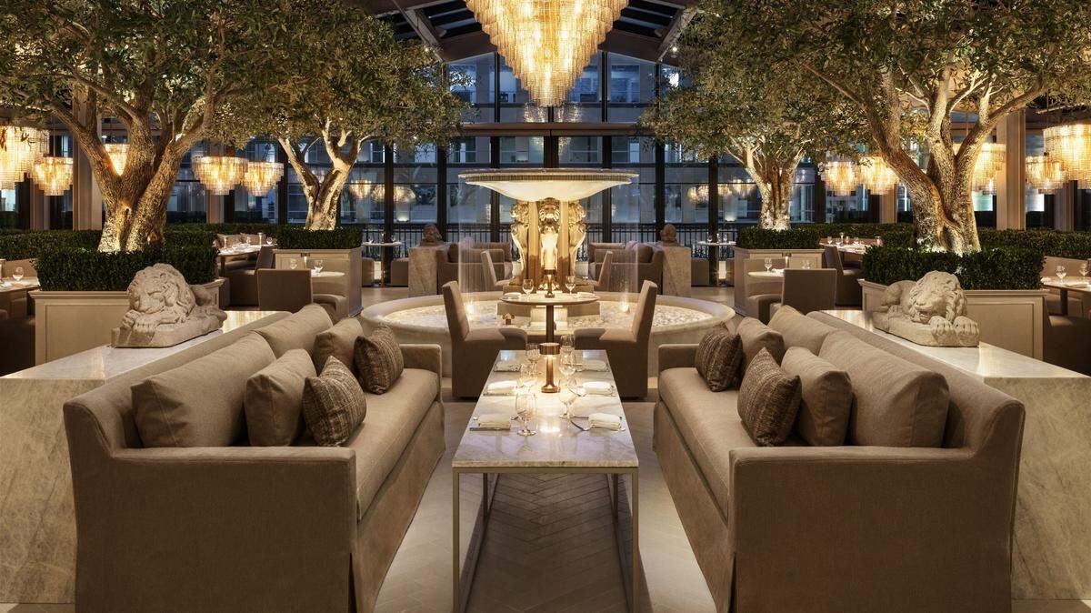 The Rooftop Restaurant at RH Gallery in Raleigh, covered in windows allowing for natural light, opens to a wine terrace overlooking North Hills.