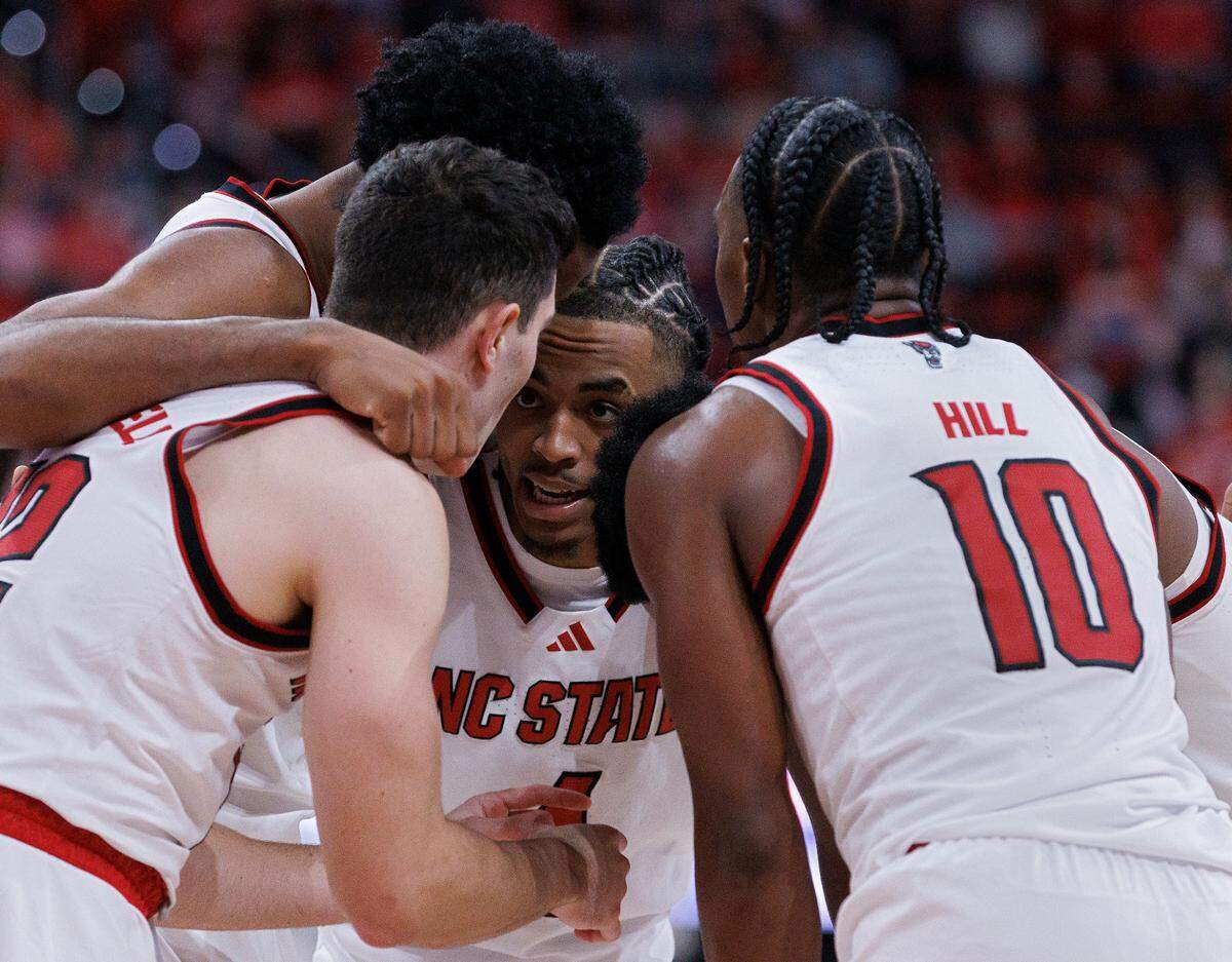 N.C. State’s Breon Pass, center, huddles with teammates during the second half of the Wolfpack’s 63-59 loss to Texas on Wednesday, Dec. 4, 2024, at Lenovo Center in Raleigh, N.C.