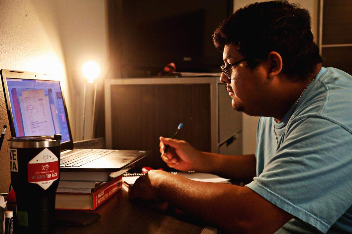 N.C. State University student senator Omar Jaramillo, 20, attends an online class at the Raleigh apartment he shares with two roommates. Jaramillo, a junior in agricultural education and engineering, who is from Goldsboro, plans to stay in Raleigh for the school year.