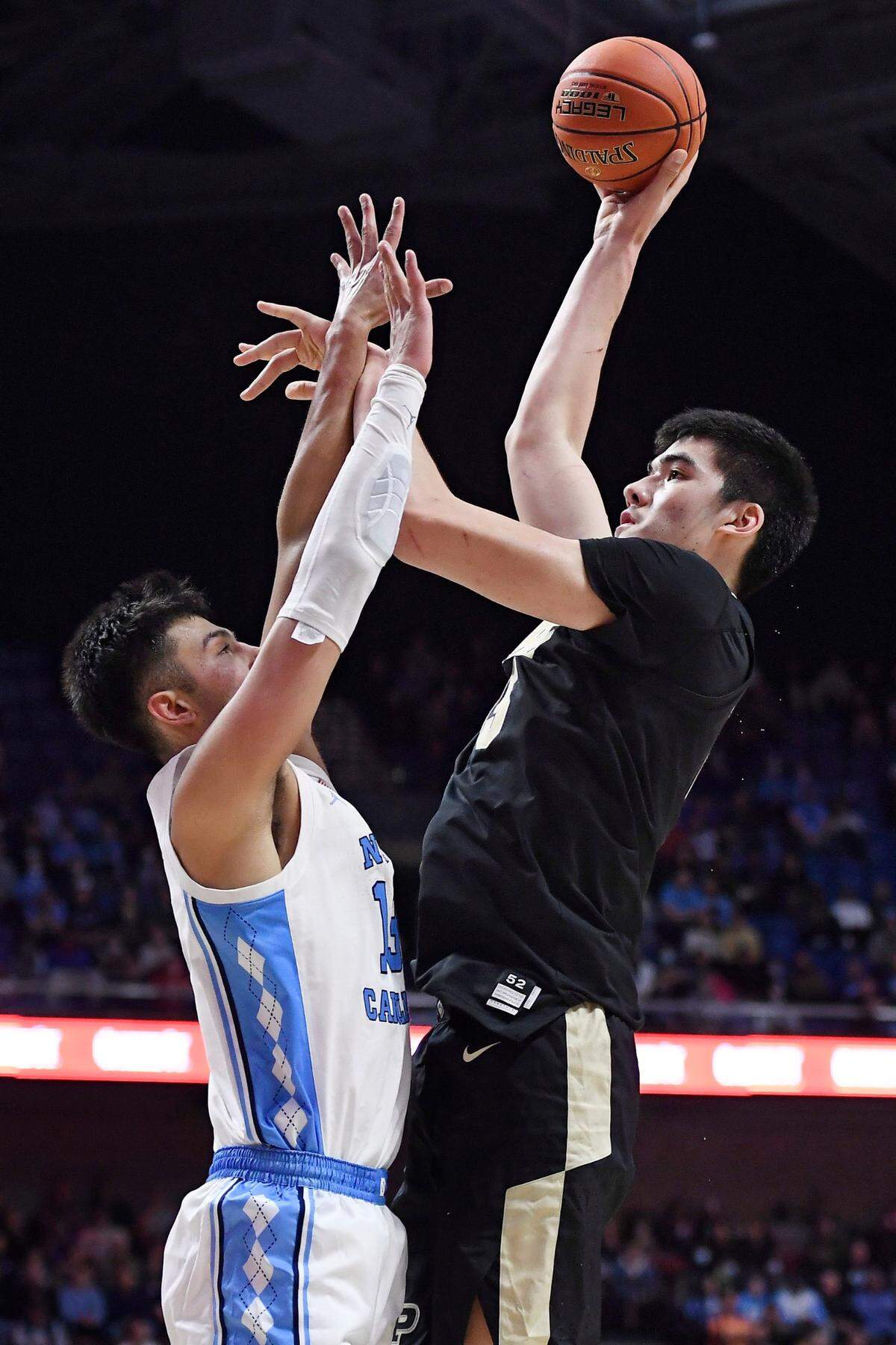 Purdue’s Zach Edey, right, shoots over North Carolina’s Dawson Garcia in the second half of an NCAA college basketball game, Saturday, Nov. 20, 2021, in Uncasville, Conn. (AP Photo/Jessica Hill)