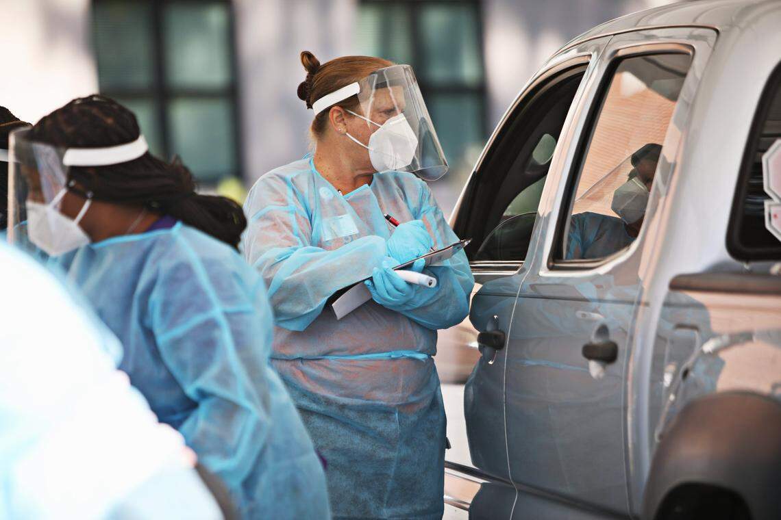 RN Tresa Webb takes details from a client at a COVID-19 testing drive-thru for Advance Community Health in Raleigh on Thursday, Nov. 5, 2020. Advance Community Health hosts several free testing sites each week.