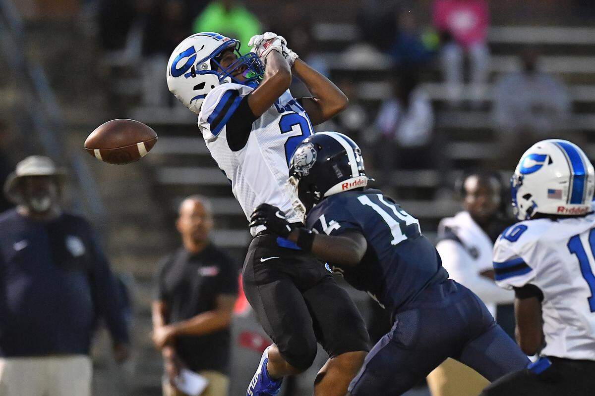Clayton defensive back Malachi Burt (20) misses the interception against Southeast Raleigh wide receiver Cam Bullock (14) during the first half. The Southeast Raleigh Bulldogs and the Clayton Comets met in a non-conference football game in Raleigh, N.C. October 3, 2025.