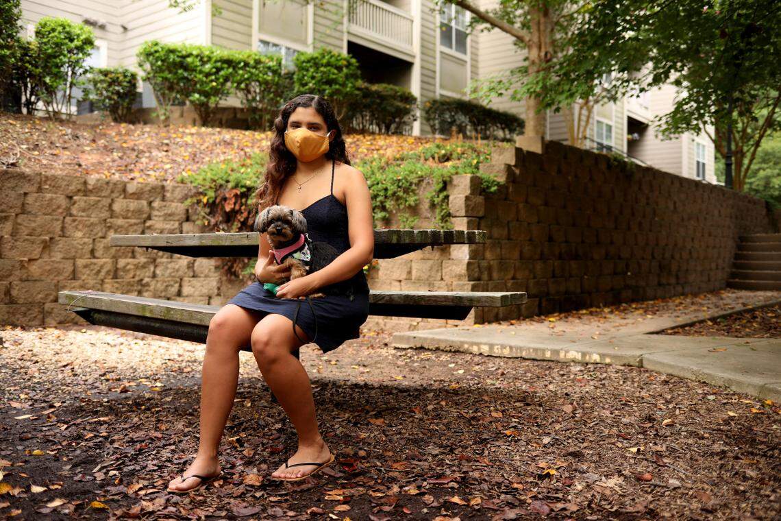 Kimberly Hernandez, 19, a sophomore at N.C. State University majoring in animal science, holds her dog, Lilo, who traveled with her from their home in Puerto Rico. Hernandez found a sublet for her apartment and was in the process of making arrangements to move back to Puerto Rico to attend online classes when this photo was taken.