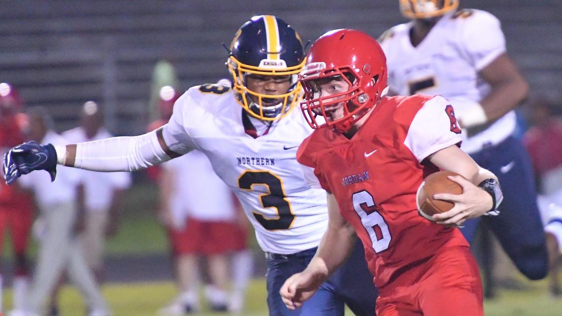 Cameron Carrow (6) of Jordan carries the ball against Cameron Traylor (3) of Northern Durham. The Northern Durham Knights visited the Jordan Falcons in a high school football game on September 6, 2019.