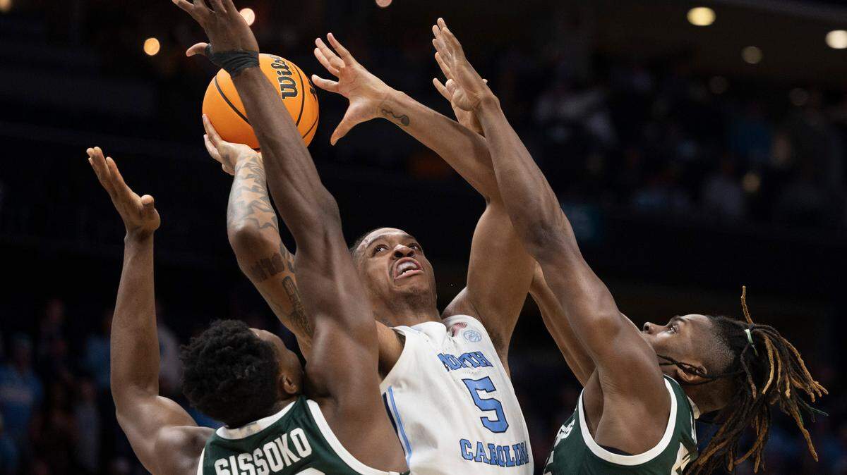 North Carolina’s Armando Bacot (5) puts up a shot against Michigan State’s Mady Sissoko (22) and Coen Carr (55) during the first half on Saturday, March 23, 2024, during the second round of the NCAA Tournament at Spectrum Center in Charlotte, N.C.