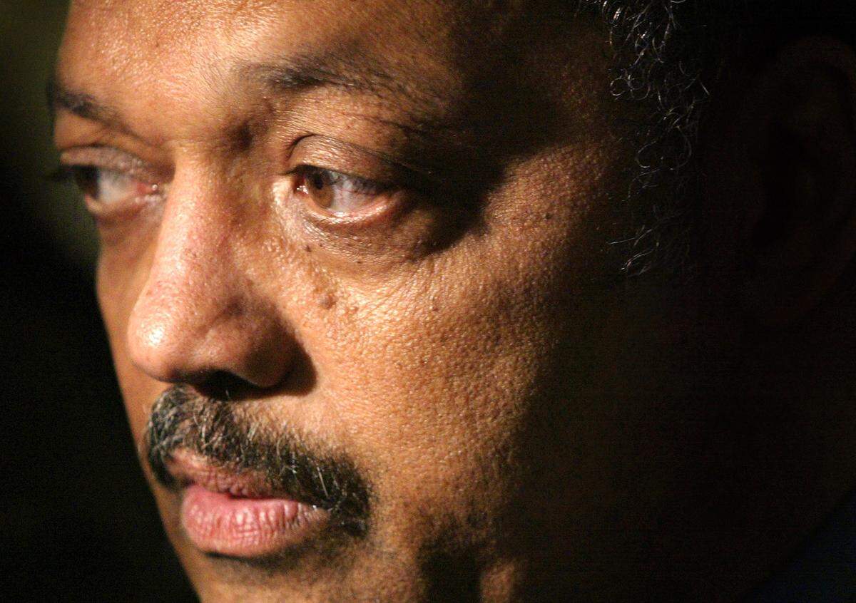 The Reverend Jesse Jackson speaks to the news media about a potential peace trip to the Middle East during a visit to Faraday Elementary School in 2002 in Chicago.
