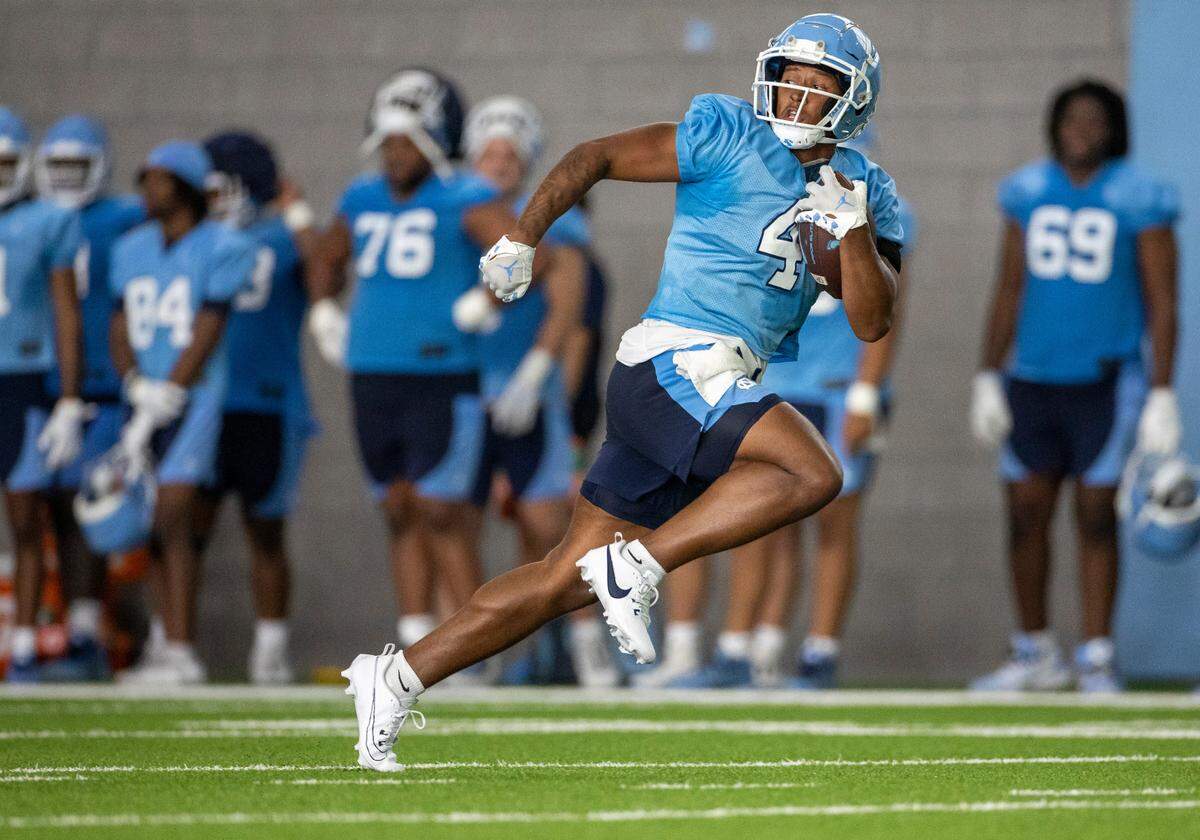 North Carolina running back Caleb Hood (4) breaks open on a long run during the Tar Heels’ first practice of the season on Wednesday, August 2, 2023 in Chapel Hill, N.C.