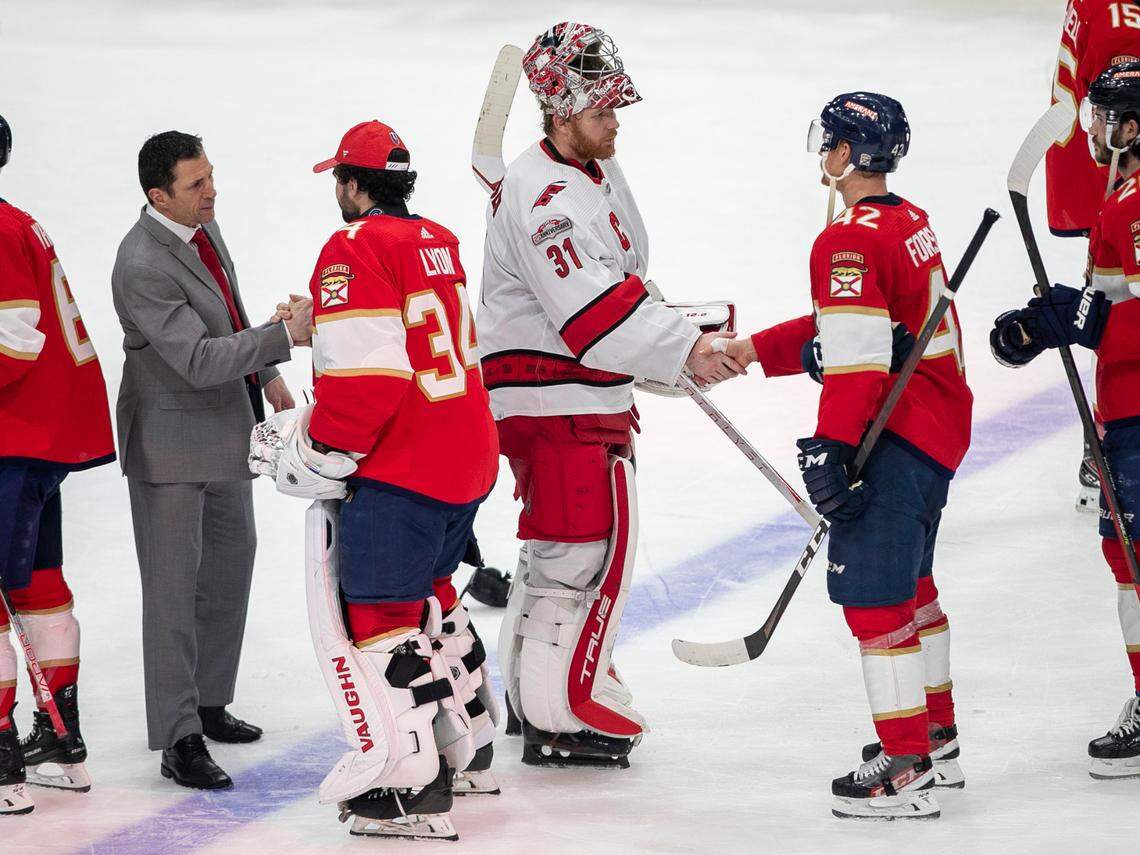 Carolina Hurricanes coach Rod Brind’Amour shakes hands with the Florida Panthers goalie Alex Lyon (34) as Frederik Andersen (31) congratulates Gustav Formling (42) following the Panthers’ 4-3 victory in the Eastern Conference Finals on Wednesday, May 24, 2023 at FLA Live Arena in Sunrise, Fla.