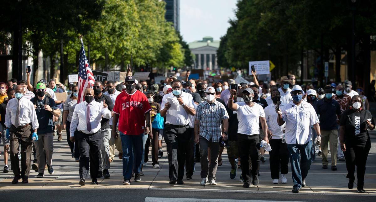 Triangle faith leaders march with hundreds down Fayetteville Street to the Capital during a Community of Faith Prayer Walk on Saturday, June 6, 2020 in Raleigh, N.C.