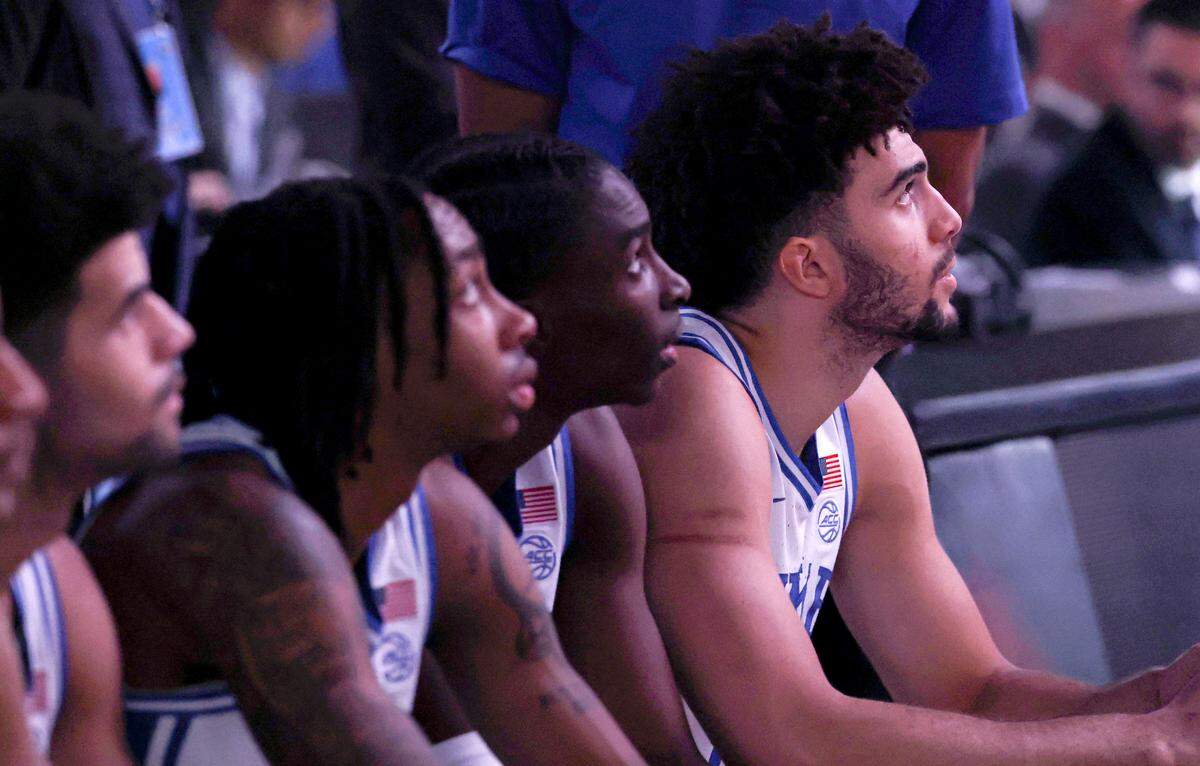 From left, DukeÕs Cayden Boozer (2), Isaiah Evans (3), Dame Sarr (7) and Cameron Boozer (12) watch a pregame video before DukeÕs game against TCU in the second round of the NCAA MenÕs Basketball Tournament at  Bon Secours Wellness Arena in Greenville, S.C., Saturday, March 21, 2026.