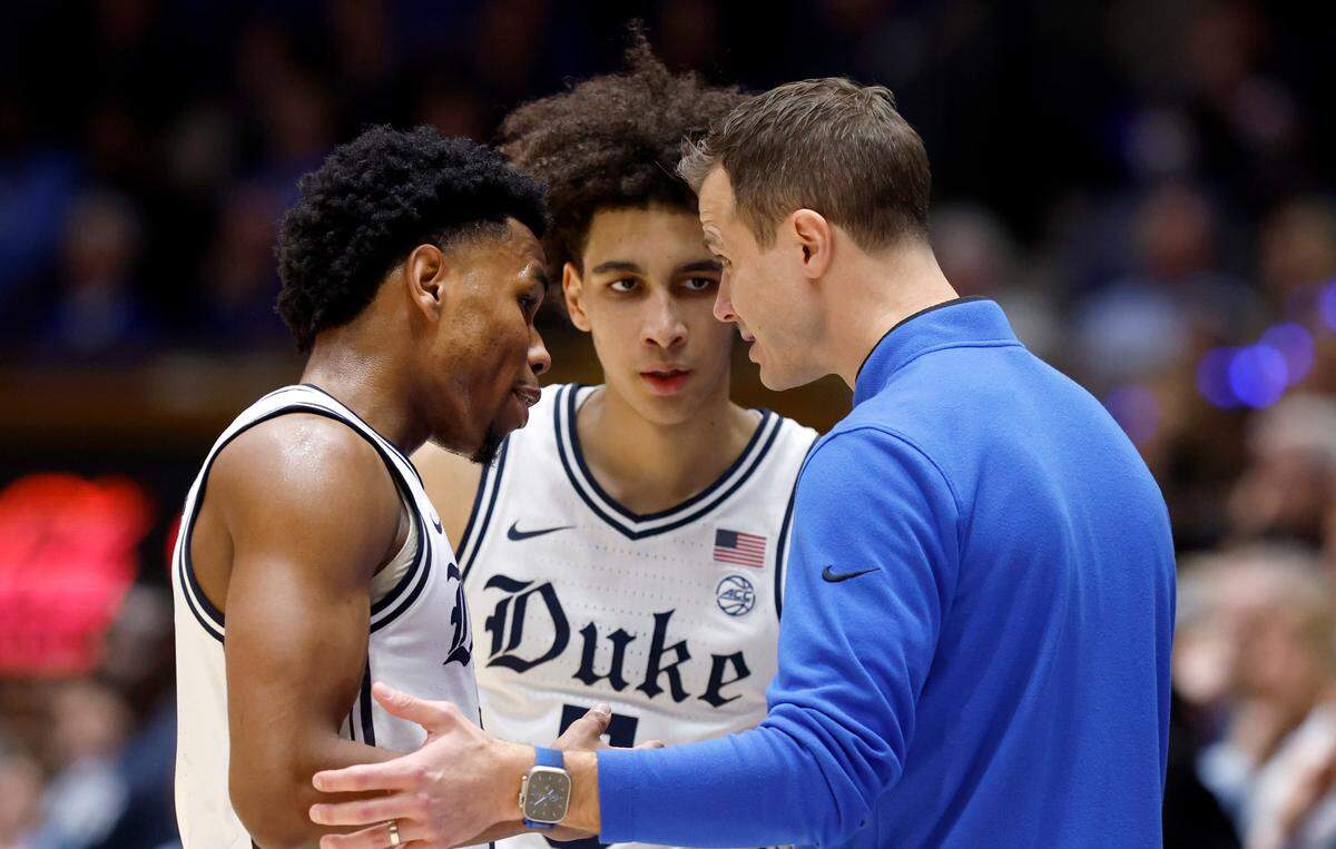 Duke head coach Jon Scheyer talks with Jeremy Roach (3) and Tyrese Proctor (5) during the first half of Duke’s game against UNC at Cameron Indoor Stadium in Durham, N.C., Saturday, Feb. 4, 2023.