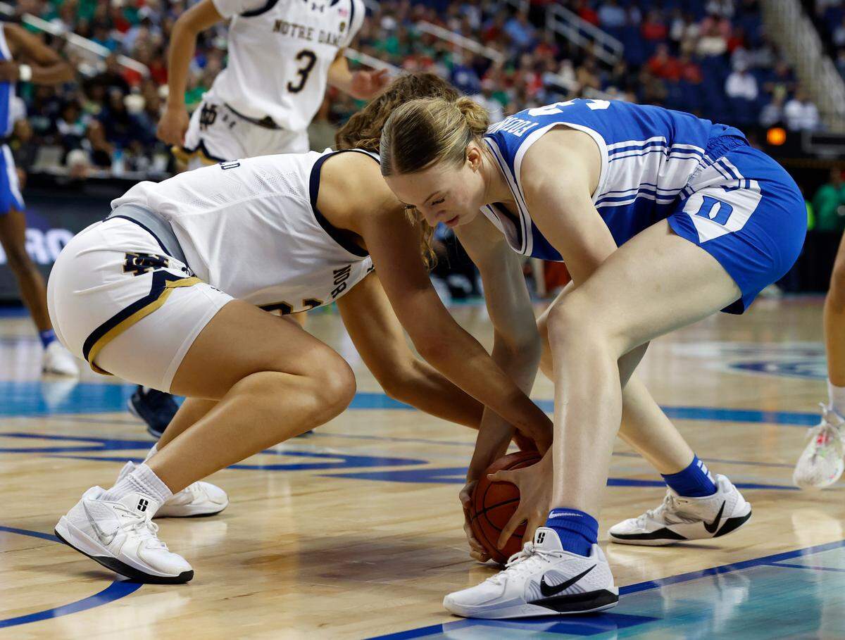 Notre Dam’s Maddy Westbeld and Duke’s Toby Fournier battle for possession during the second half of the Blue Devils’ 61-56 ACC Tournament semifinal win on Saturday, March 8, 2025, at First Horizon Coliseum in Greensboro, N.C.