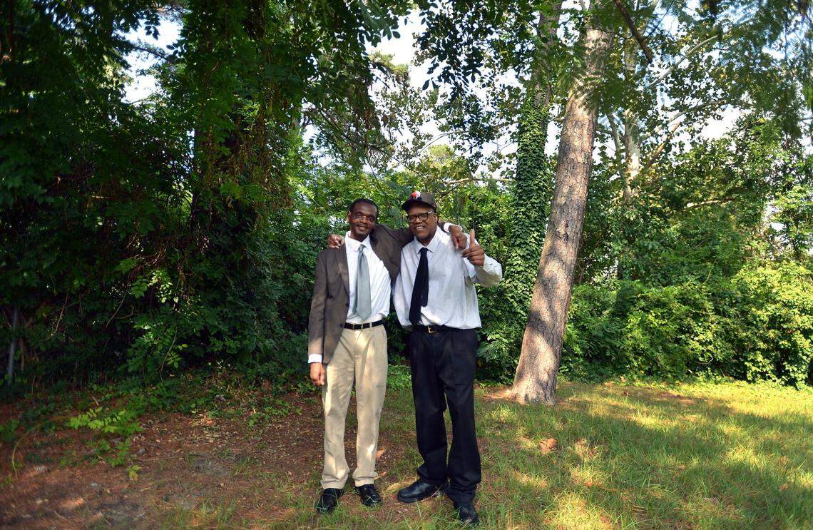 Leon Brown, right, gives a “thumbs up” as he poses with his older brother, Henry McCollum at his sister’s backyard in Fayetteville, N.C. in 2014. The brothers were enjoying their first day of freedom after their rape and murder conviction was dismissed.