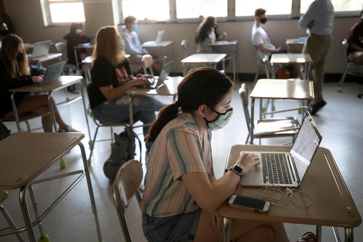Broughton High School student Maggie Montgomery attends Marlin Jones’ American History class on Thursday, April 8, 2021 in Raleigh, N.C. More than 1,200 students returned for in-person classes on Thursday at Broughton.