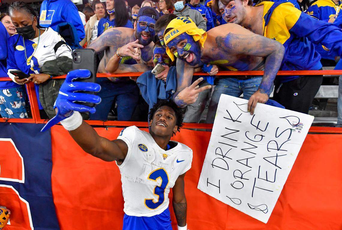 Pittsburgh wide receiver Jordan Addison (3) takes a selfie with fans after a win against Syracuse in an NCAA college football game in Syracuse, N.Y., Saturday, Nov. 27, 2021.