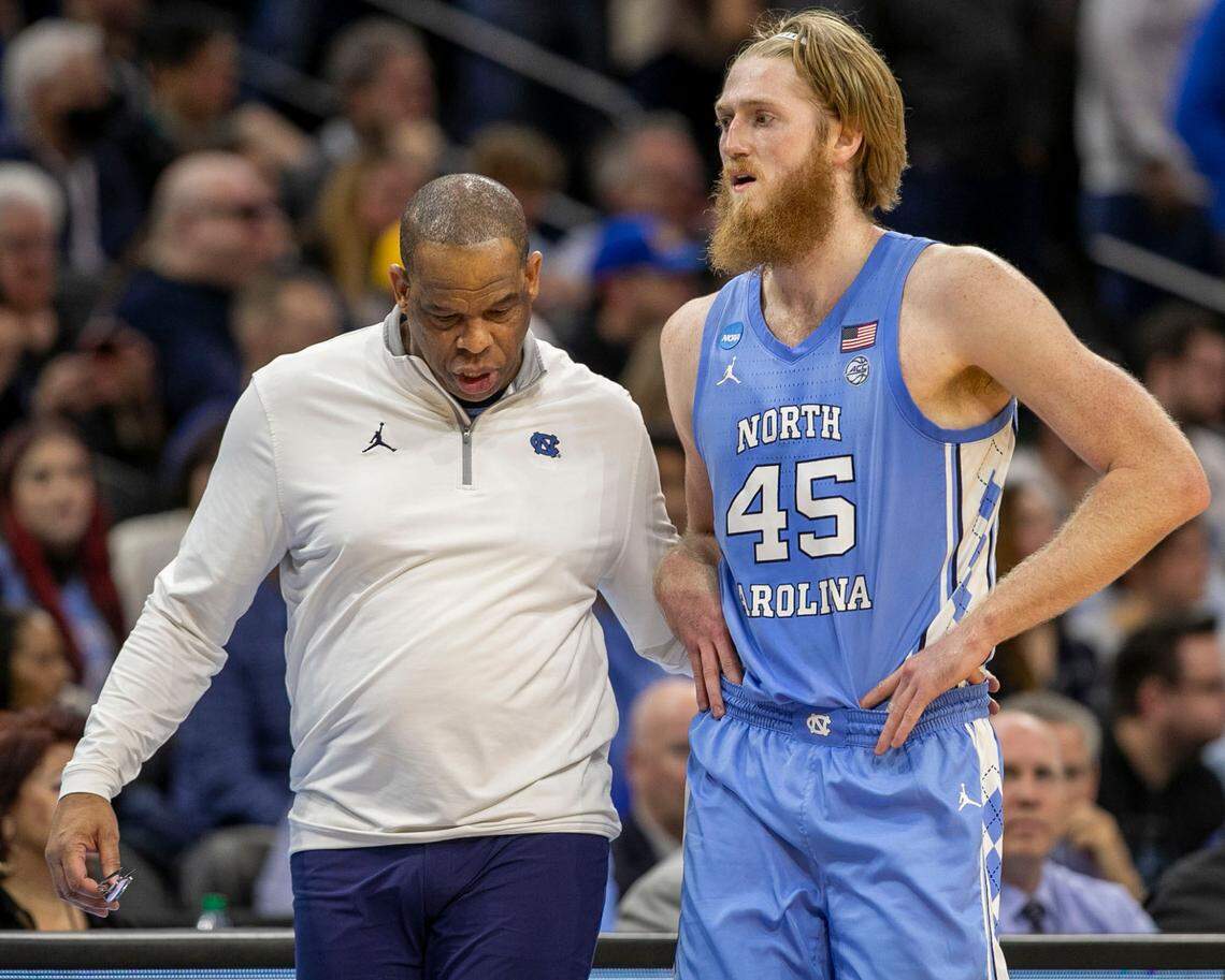 North Carolina coach Hubert Davis embraces Brady Manek (45) as he come out of the game in the second half against UCLA on Friday, March 25, 2022 during the NCAA East Regional semi-final at Wells Fargo Center in Philadelphia, Pa.