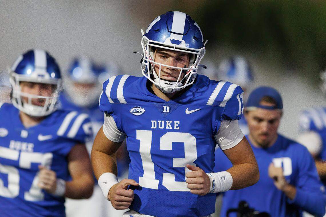 Duke’s Riley Leonard (13) runs onto the field prior to the start of an NCAA college football game against Virginia in Durham, N.C., Saturday, Oct. 1, 2022. (AP Photo/Ben McKeown)