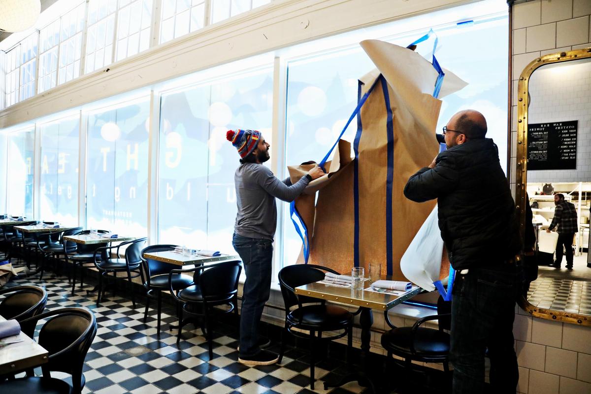 Paper is finally removed from the windows at Saint James on Jan. 8, 2020, as they prepare to reopen on Jan. 23, 2020. The restaurant was closed for several months after the Durham gas explosion last April.