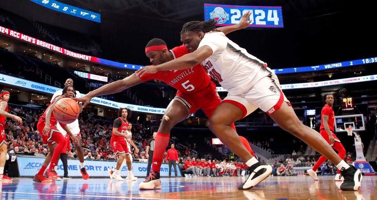 N.C. State’s DJ Burns Jr. (30) and Louisville’s Brandon Huntley-Hatfield (5) go after the ball during N.C. State’s 94-85 victory over Louisville in the first round of the 2024 ACC Men’s Basketball Tournament at Capital One Arena in Washington, D.C., Tuesday, March 12, 2024.