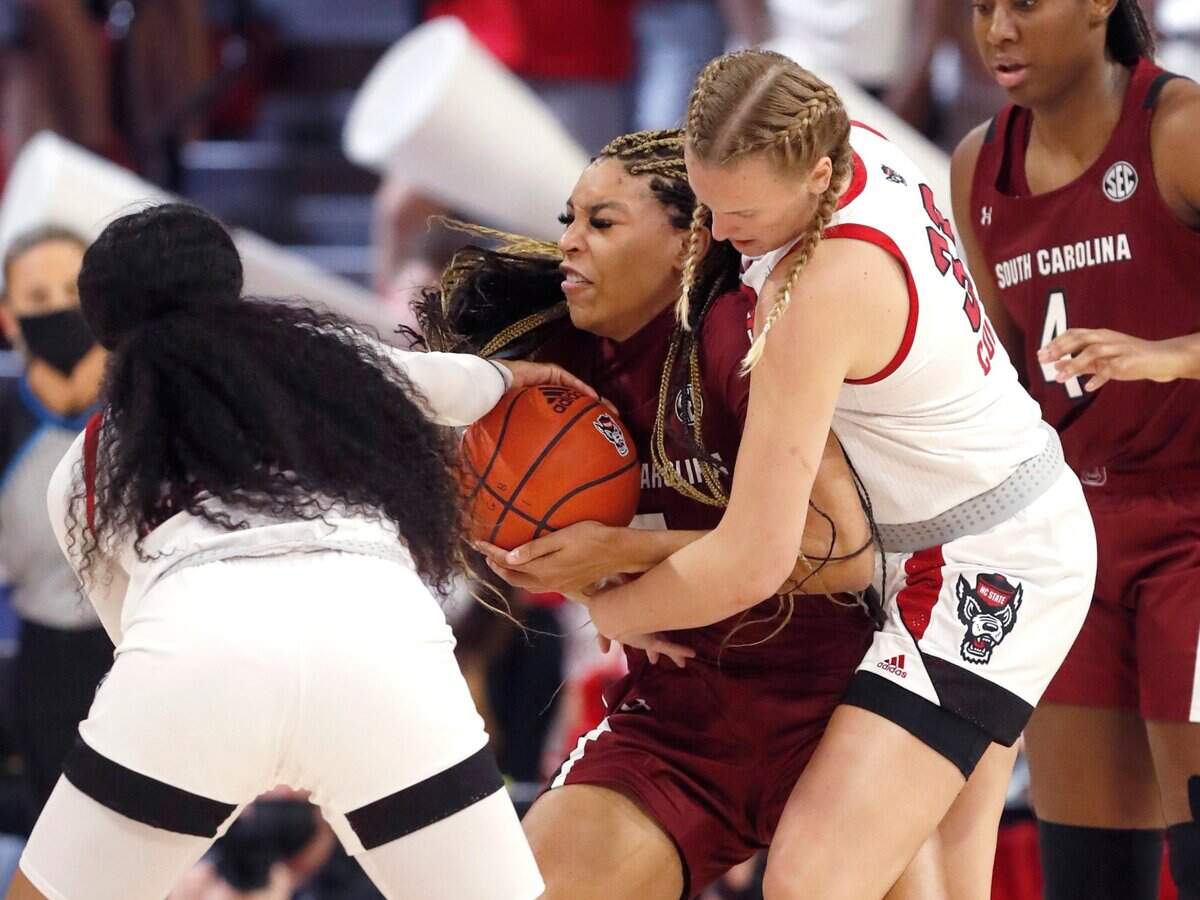 N.C. State’s Elissa Cunane (33), right, and Jakia Brown-Turner (11) pressure South Carolina’s Victaria Saxton (5) during the first half of N.C. States game against South Carolina at Reynolds Coliseum in Raleigh, N.C., Tuesday, November 9, 2021.