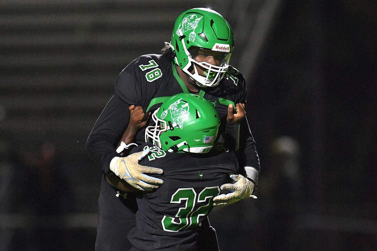 Cary’s Santonis Wright (32) celebrates his touchdown against Athens Drive with Trey Blue (78) in the second half. The Cary Imps and the Athens Drive Jaguars met in a football game in Cary, N.C. on September 6, 2024. Athens Drive wins 28-13.