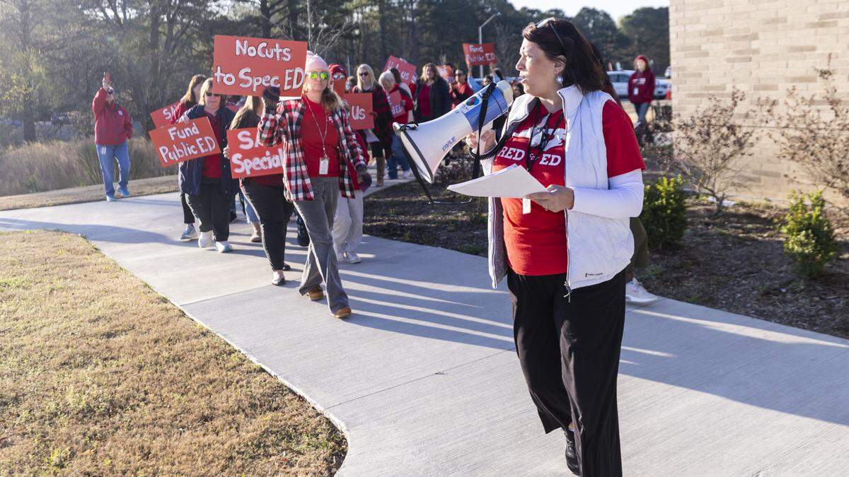 Educators and parents picket outside Fuquay-Varina Elementary School on Thursday, urging Wake County school leaders to prevent budget cuts that would reduce spending on special education programs.