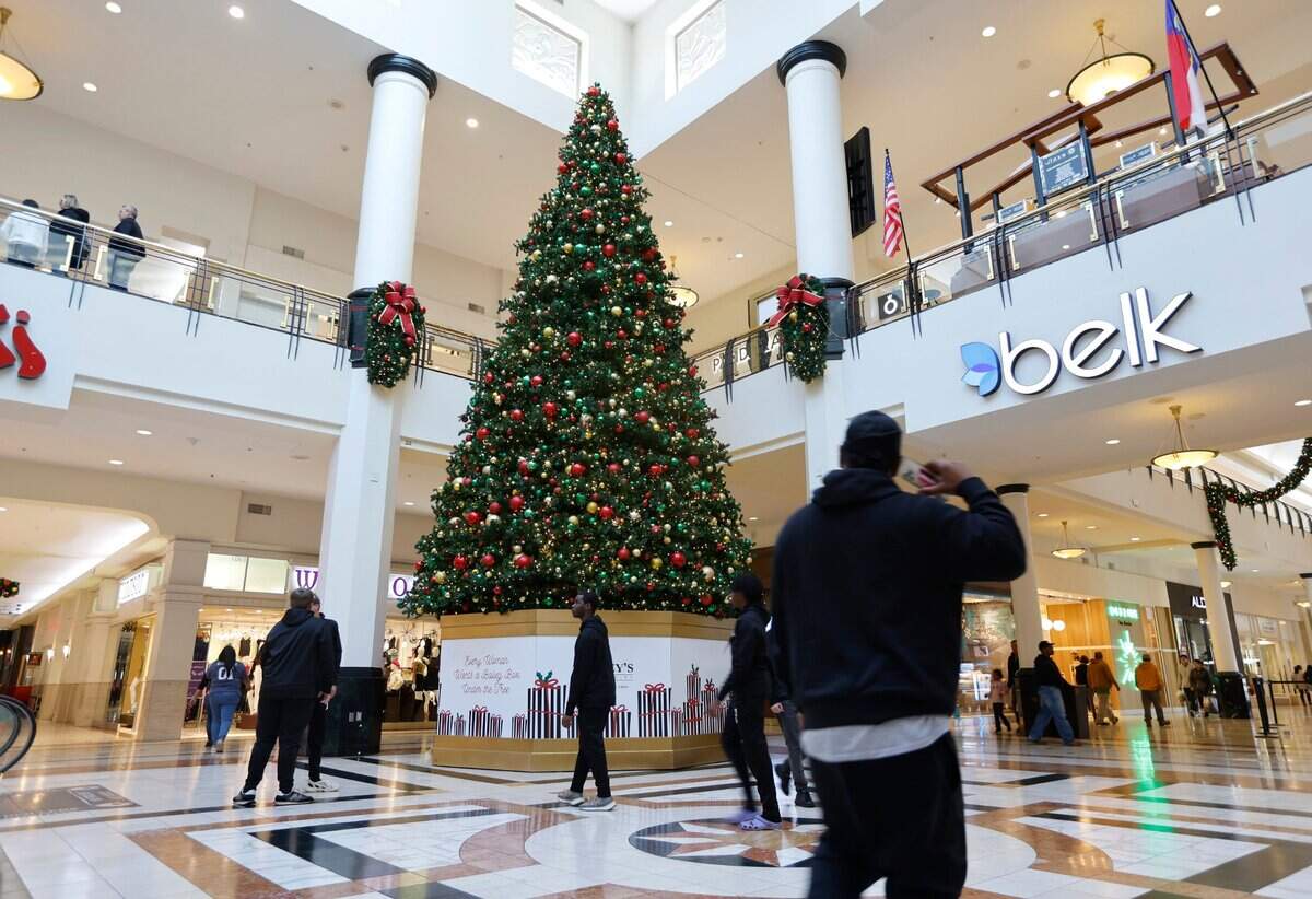 Shoppers walk through Center Court at Crabtree Valley Mall in Raleigh, N.C., Friday, Nov. 18, 2022.