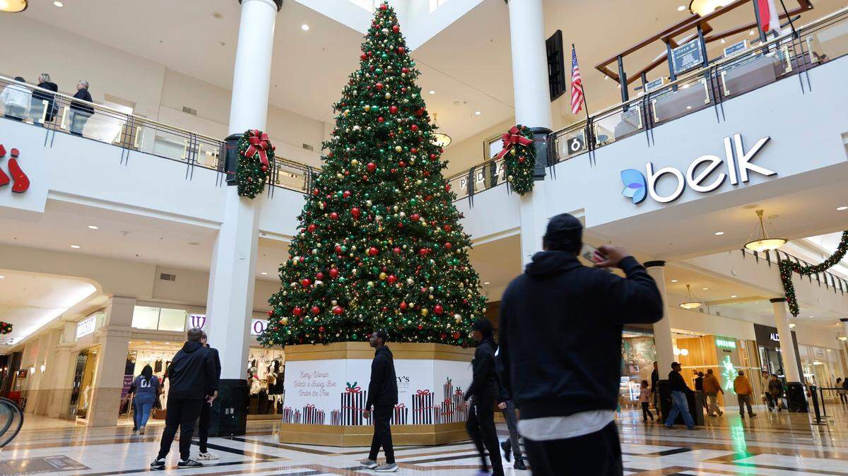 Shoppers walk through Center Court at Crabtree Valley Mall in Raleigh, N.C., Friday, Nov. 18, 2022.