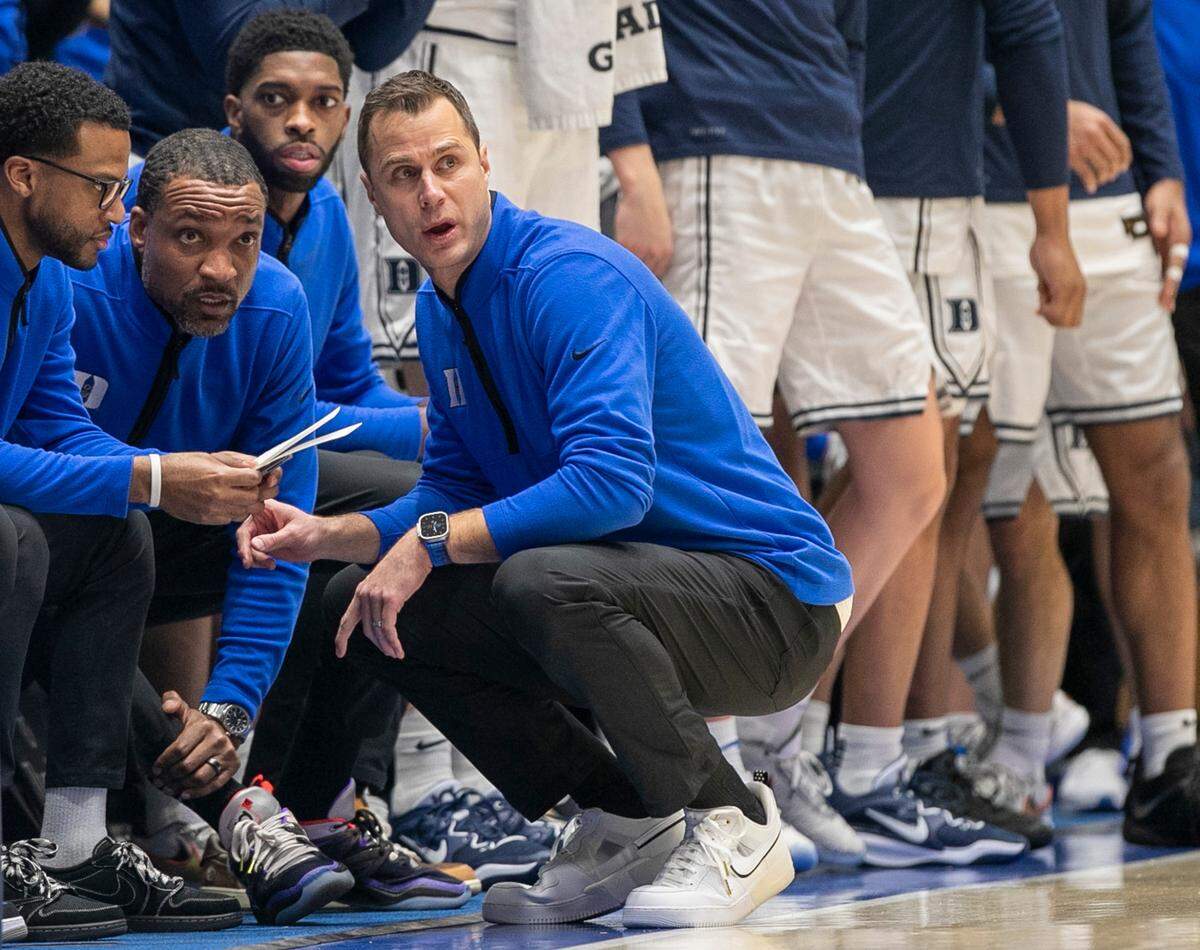 Duke coach Jon Scheyer huddles with his assistants, Jai Lucas, Chris Carrawell and Amile Jefferson in the second half against North Carolina on Saturday, February 4, 2023 at Cameron Indoor Stadium in Durham, N.C.