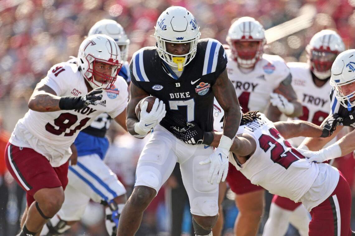 Duke Blue Devils running back Jordan Waters (7) runs the ball as Troy Trojans running back Tae Meadows (22) attempts to make the tackle during the Birmingham Bowl Saturday, Dec. 23, 2023.