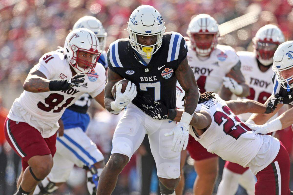 Duke Blue Devils running back Jordan Waters (7) runs the ball as Troy Trojans running back Tae Meadows (22) attempts to make the tackle during the Birmingham Bowl Saturday, Dec. 23, 2023.