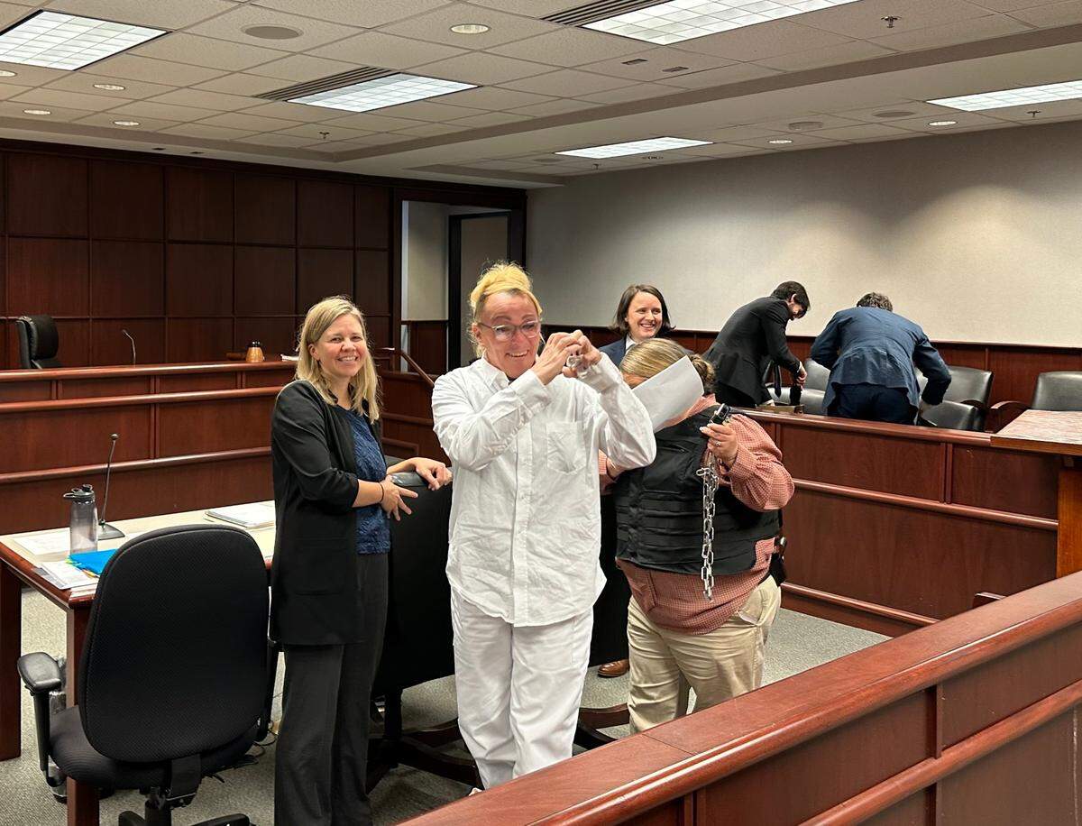 Ashlee Inscoe, a transgender woman who was born intersex, smiles and waves at friends and supporters at the Wake County Courthouse on Tuesday, Nov. 21, 2023, after a judge ruled that she must be transferred to a women’s prison.