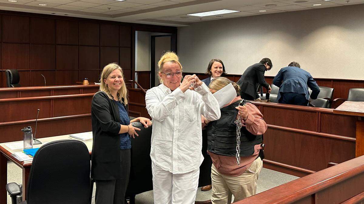 Ashlee Inscoe, a transgender woman who was born intersex, smiles and waves at friends and supporters at the Wake County Courthouse on Tuesday, Nov. 21, 2023, after a judge ruled that she must be transferred to a women’s prison.