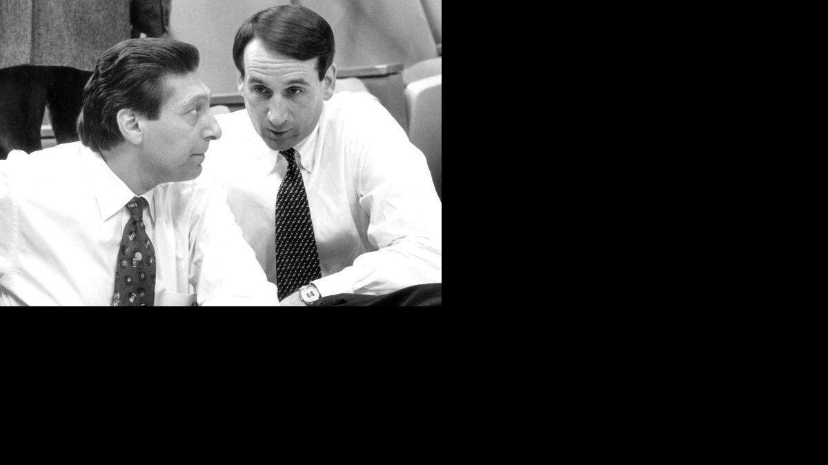 Duke coach Mike Krzyzewski (right) with former N.C. State coach Jim Valvano in the stands before Carolina's March 7, 1993 basketball game with Duke. Valvano died of cancer seven weeks later on April 28.
